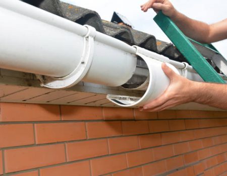 Roof gutter repair. Guttering repair. Roofer contractor repair house rain gutter pipeline.
